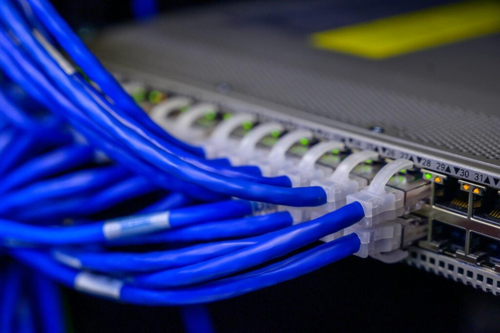 Copper Cabling 1 Detailed view of blue ethernet cables connected to a network switch in a data center.