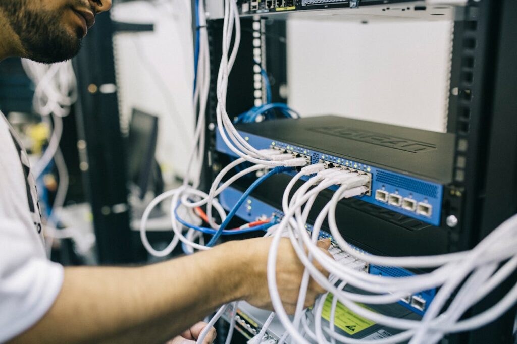 A person plugs cables into machine.